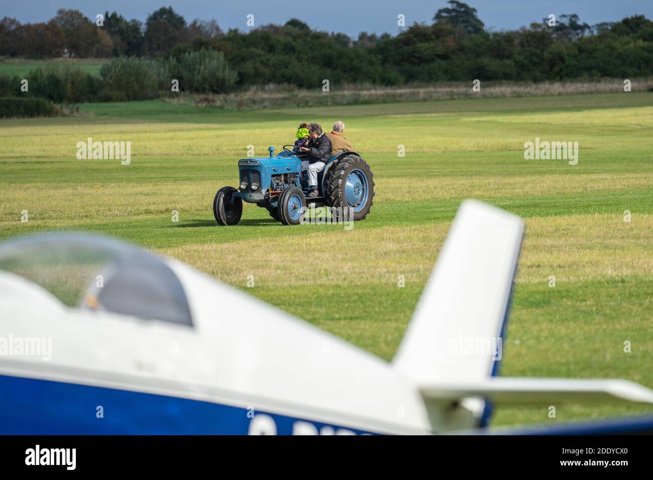 Tractor driving along the airfield runway to pick up the glider. OLD