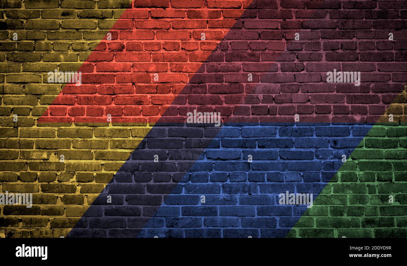 Brick wall painted with multi-colored paints. Abstract background. The old wall. Stock Photo