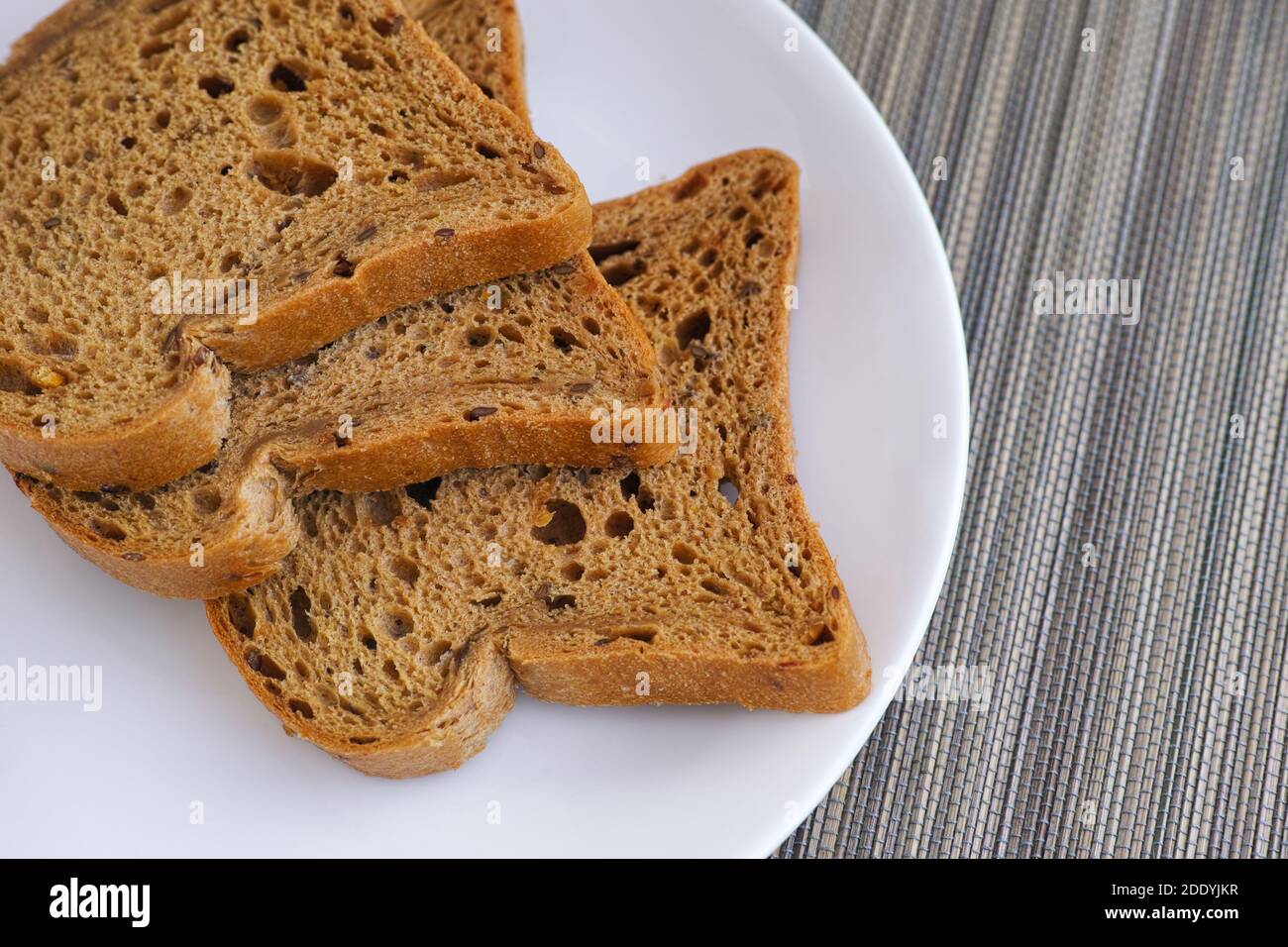 Slices of whole grain gluten free bread on a plate. Close up. Stock Photo
