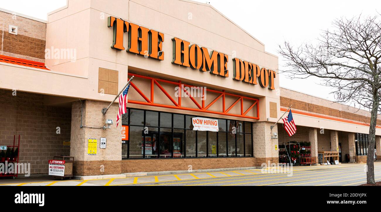 Bay Shore, New York, USA - 22 November 2020: The front façade of a Home Depot store with a help wanted sing and an American Flag. Stock Photo