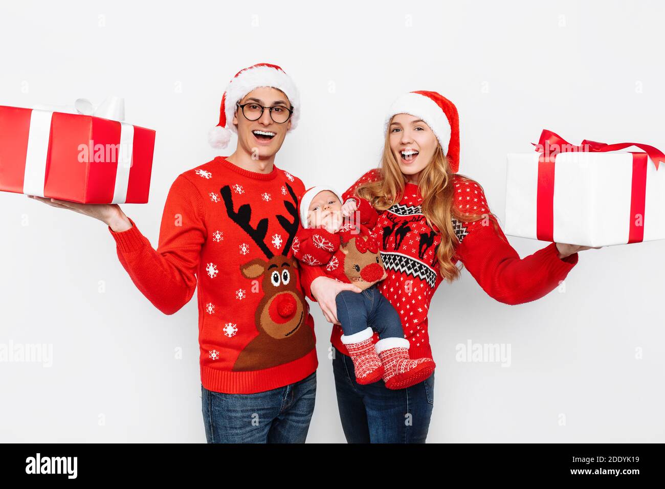 Happy family, mom, dad and little child celebrate Christmas with