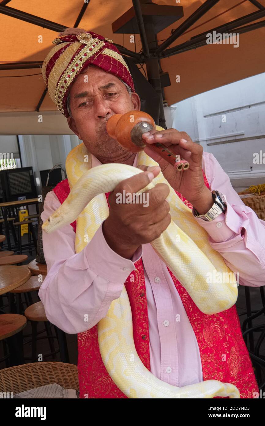 An ethnic Indian snake charmer in Singapore, usually entertaining ...