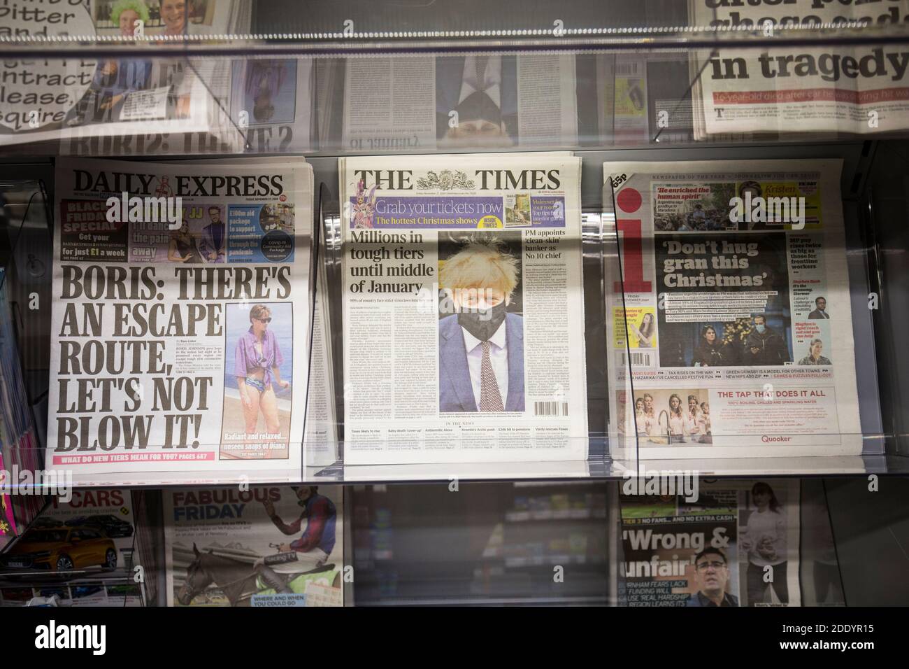 Newspapers with Boris Johnson and Covid-19 headlines on sale in a UK supermarket Stock Photo