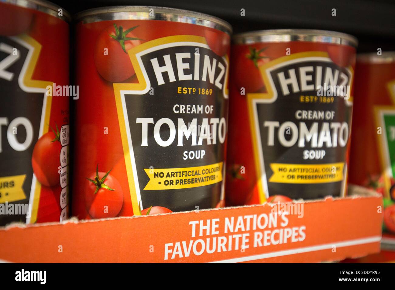 Tins of Heinz tomato soup on a supermarket shelf in England Stock Photo
