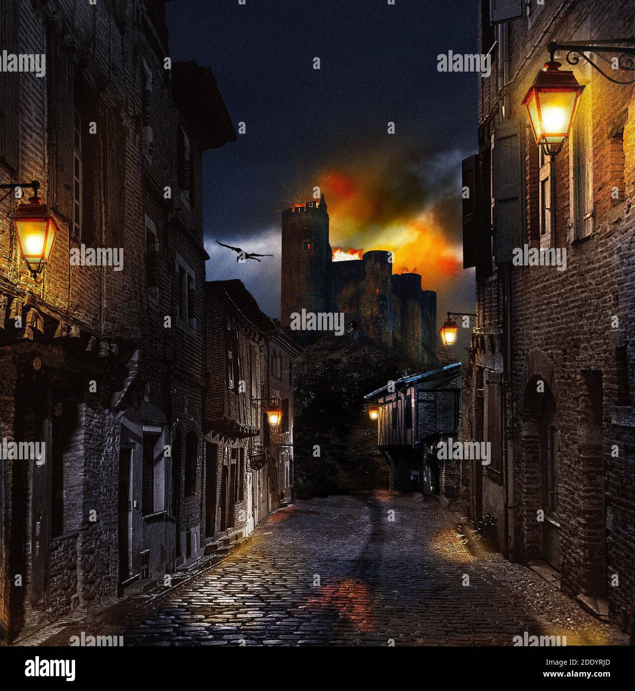 A dusk Photoshop diorama of a burning medieval castle, seen from a nearby village. A silhouetted dragon flies over the scene in the background. Stock Photo