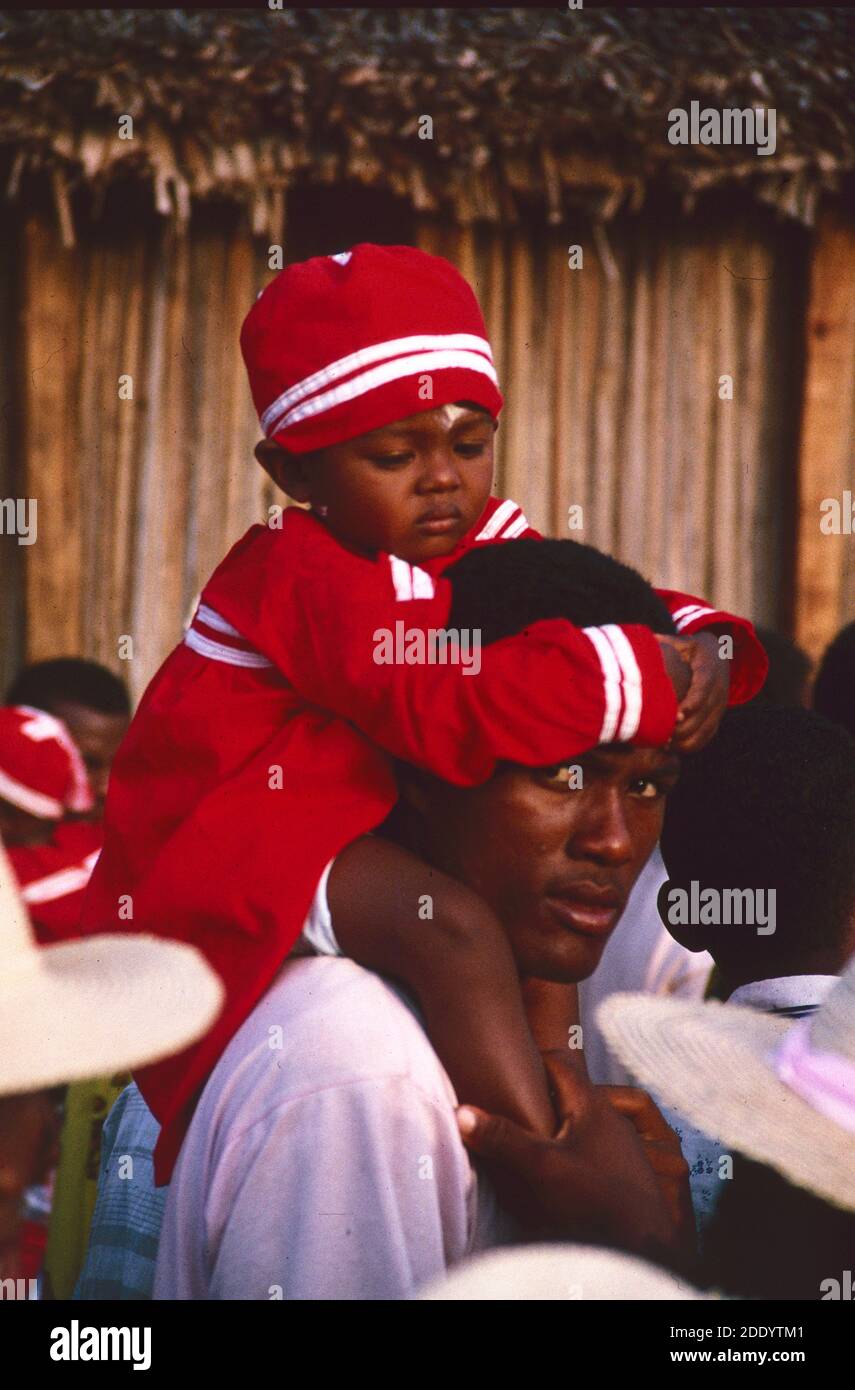 Boy & Father or Father & Son at the Sambatra Circumcision Festival with Boy in Circumcision Costume Carried on Father's Shoulders  in Mananjary western Madagascar Stock Photo