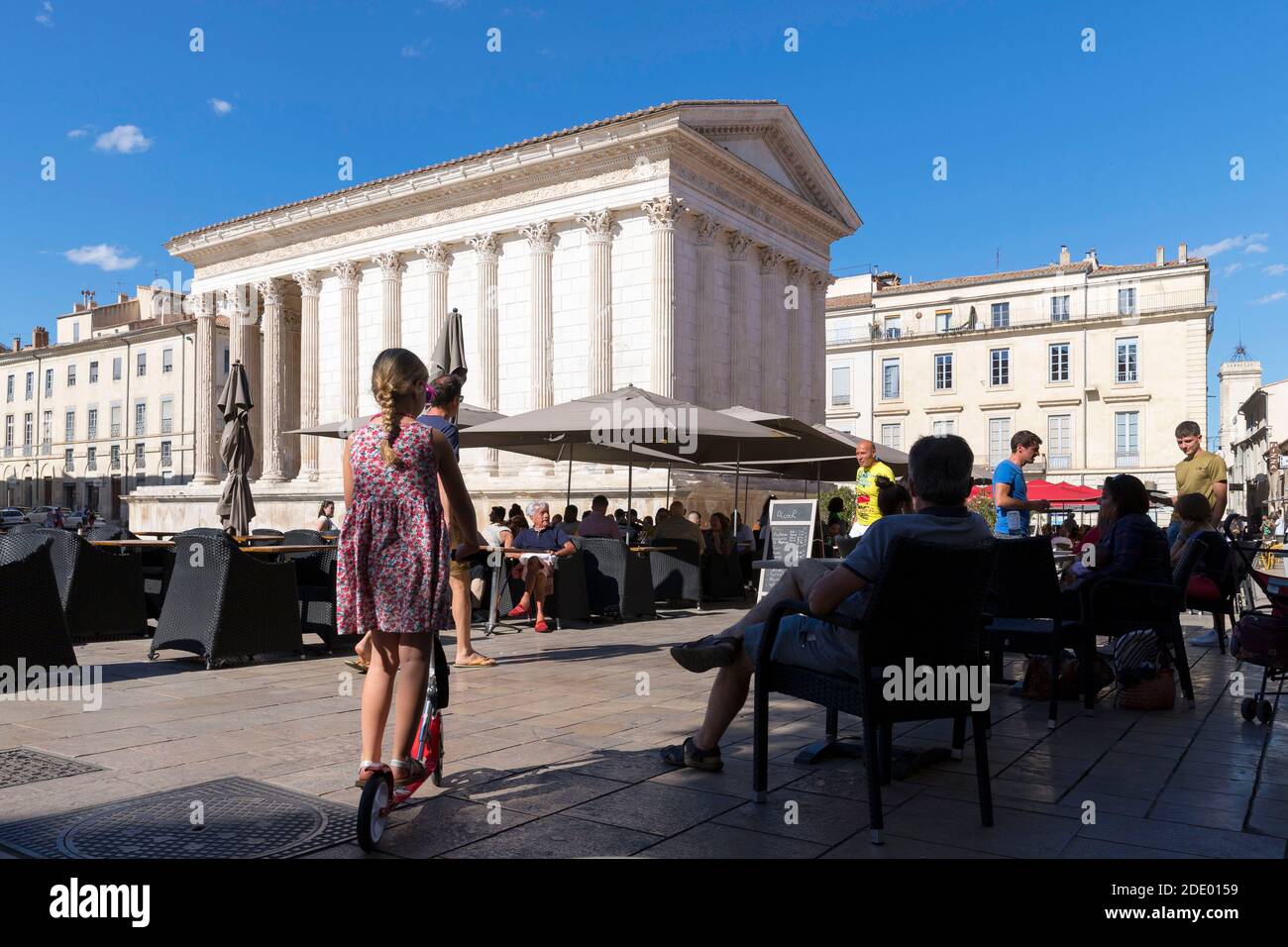 Nimes (south-eastern France): the Roman temple “Maison Carree” (Square House) viewed from the terrace of the “Ciel de Nimes” restaurant. Atmosphere on Stock Photo