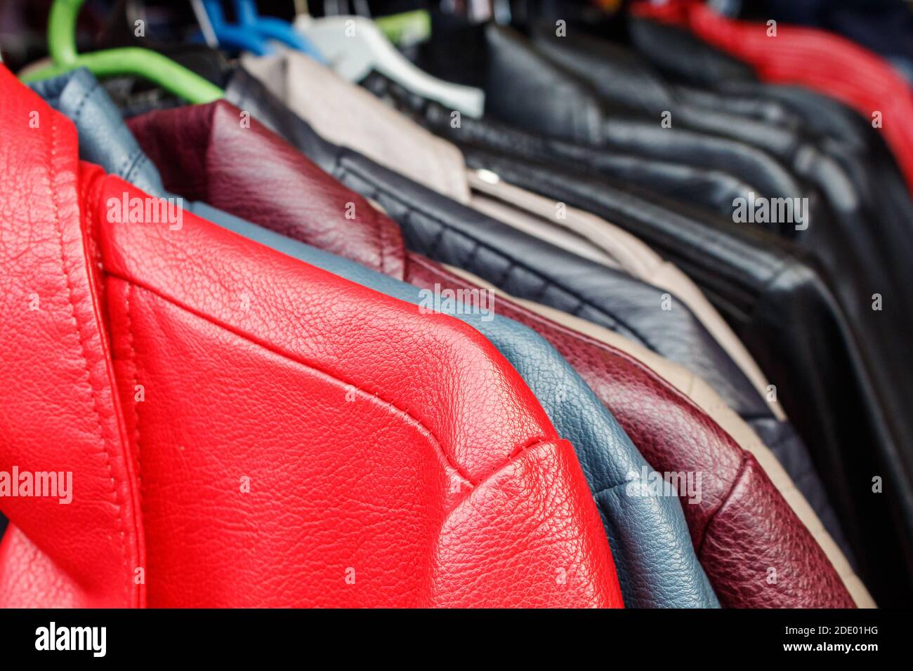 leather jackets hanging on a hanger in the city market outdoor on