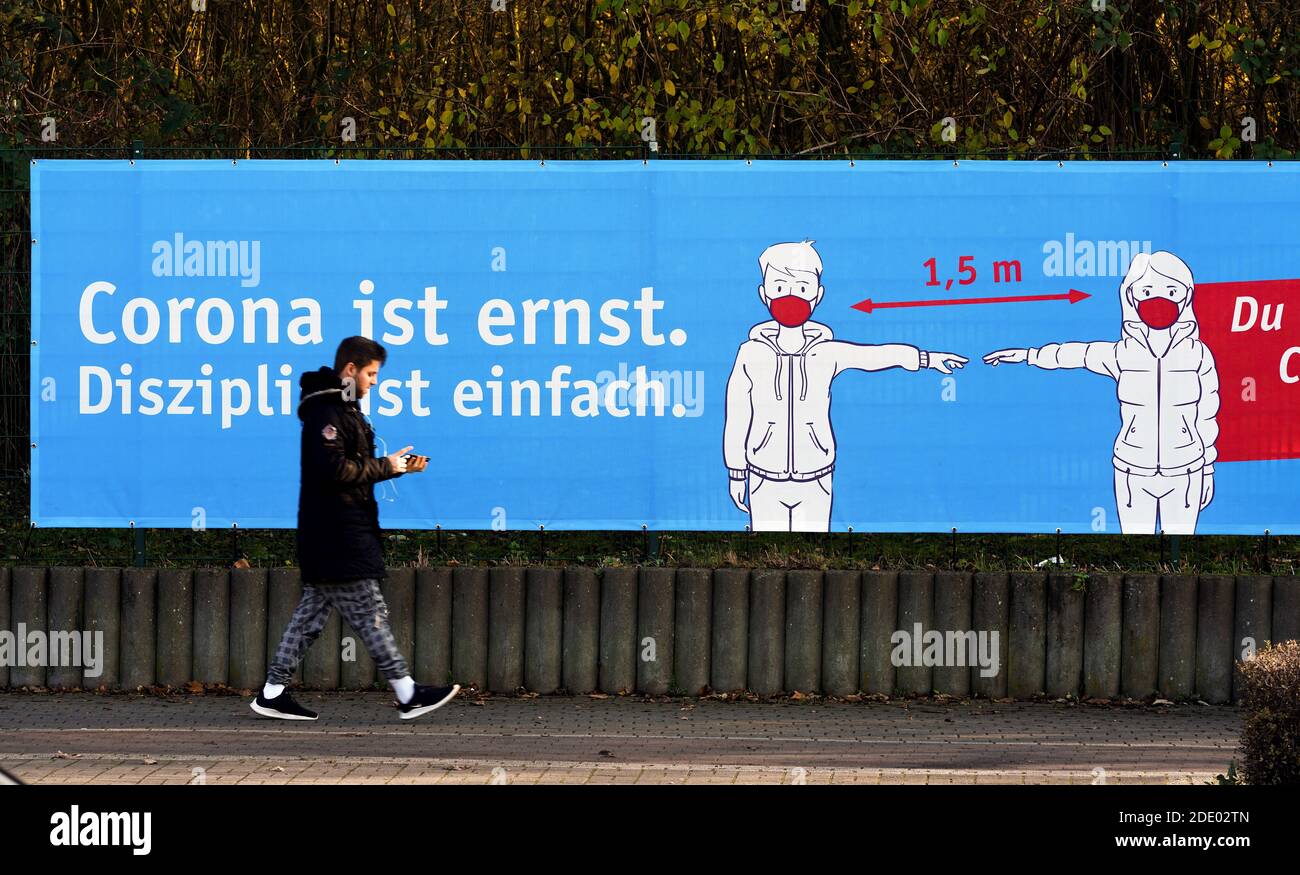 Herne, Germany, November 27th, 2020: Due to the corona pandemic, administration and city marketing appeal with banners and posters to observe the minimum distance of 1.50 meters and to wear mouth and nose protection. Stock Photo