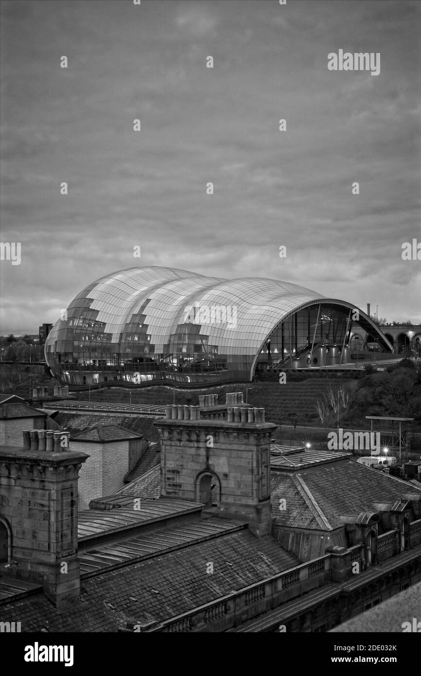 Captured from the Tyne Bridge in Newcastle upon Tyne, these chimney stacks on old buildings on the Quayside contrast with the ultra modern architectur Stock Photo