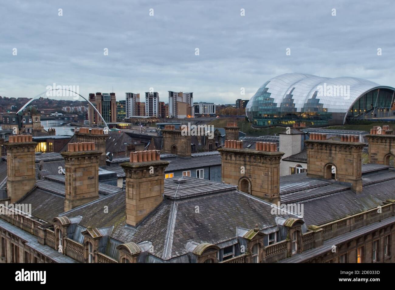Captured from the Tyne Bridge in Newcastle upon Tyne, these chimney stacks on old buildings on the Quayside contrast with the ultra modern architectur Stock Photo