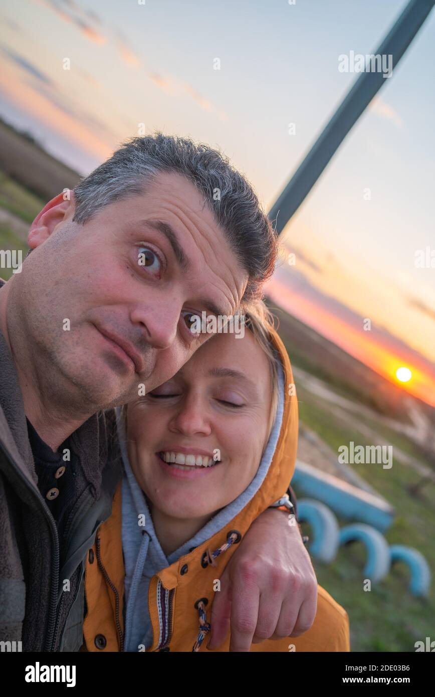 Emotional Man hugs his wife when makes selfie Stock Photo