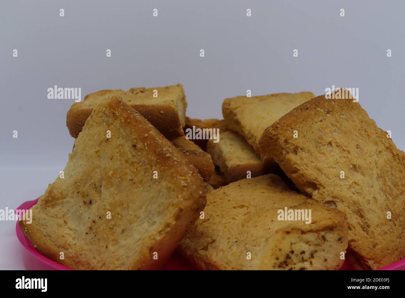 Stack of plain melba toasts on white Background. Edible square dry