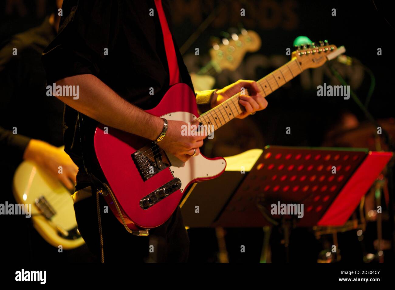 Guitar rock band on stage at a concert Stock Photo