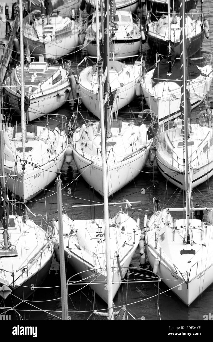 A vertical grayscale shot of boats in a port Stock Photo - Alamy