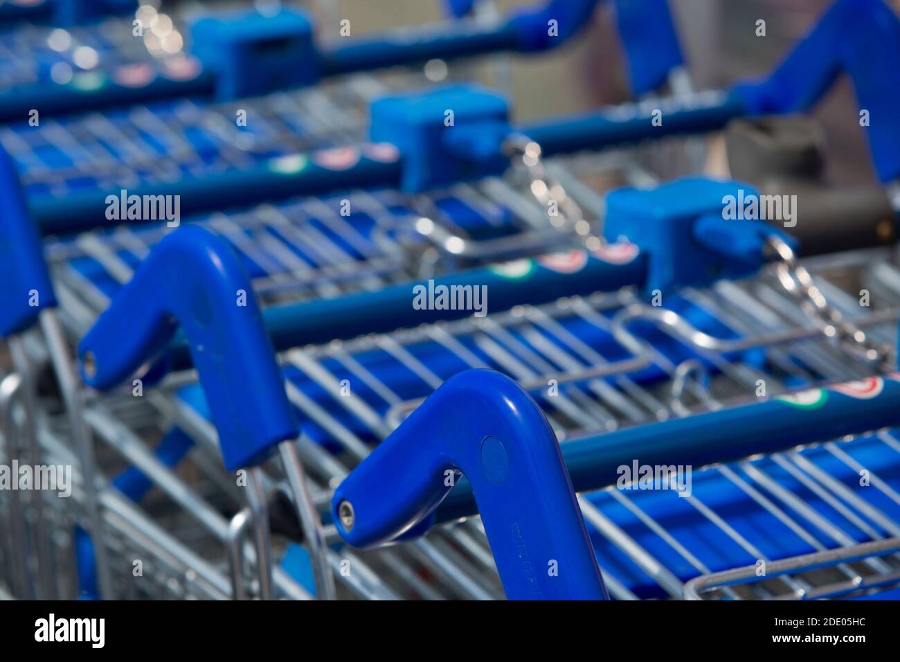Close up of blue supermarket trolleys ready for use outside  a large UK supermarket in a retail park Stock Photo