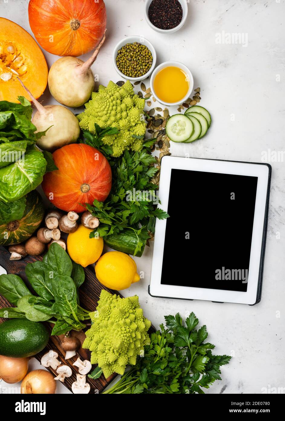 Tablet computer with ingredients for cooking healthy food Stock Photo