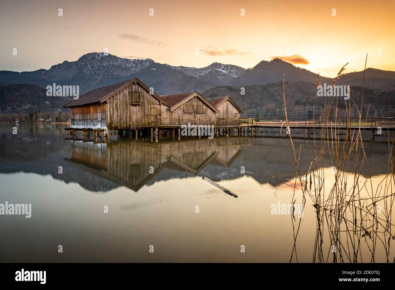 Boat houses on Lake Kochelsee at sunset. Stock Photo