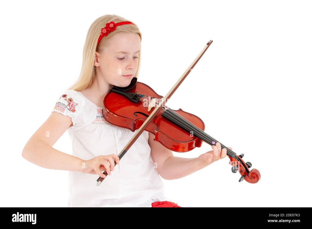 Young blonde girl plays violin on a white studio background Stock Photo ...
