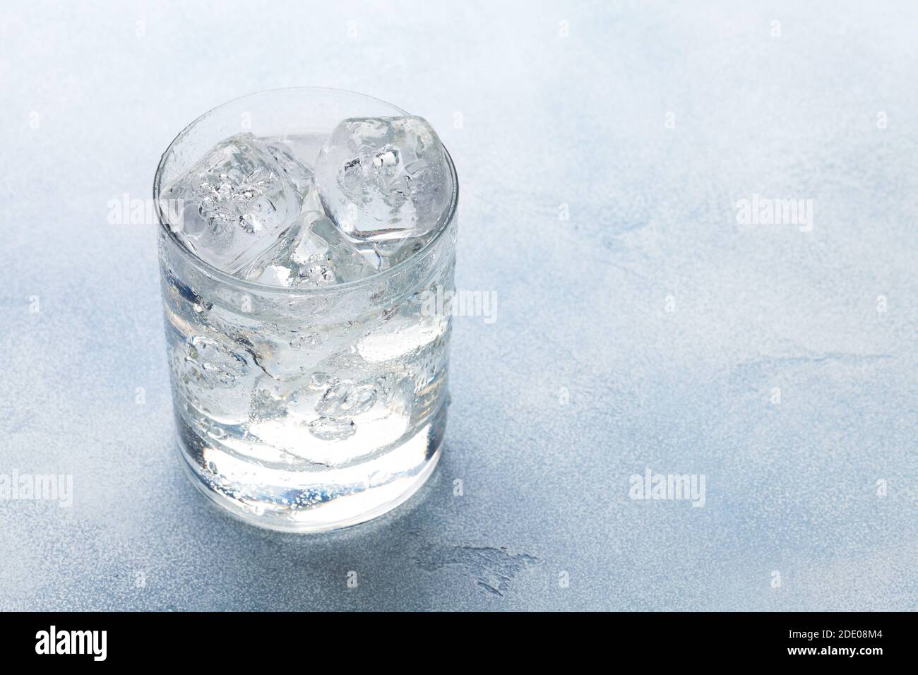 Glass of water with ice cubes. With copy space Stock Photo - Alamy