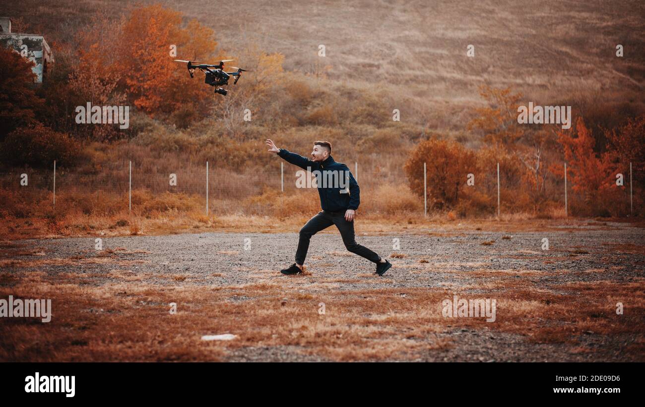 Man trying to close a camera on drone Stock Photo