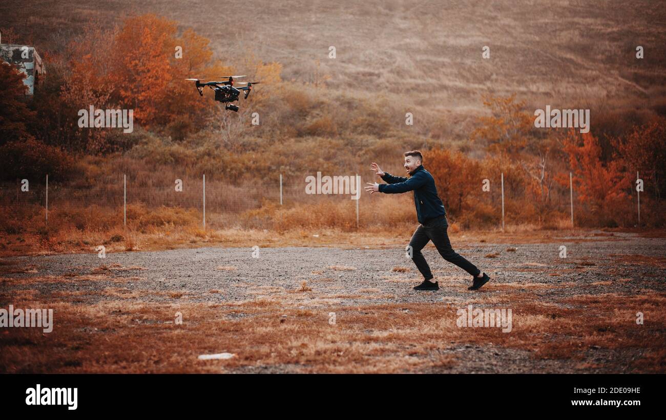 Bearded man plays with dron Stock Photo