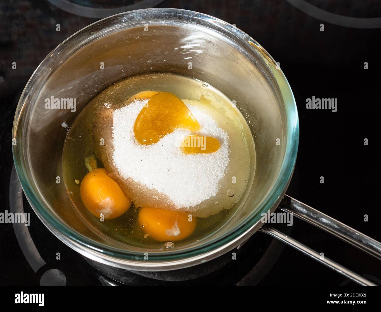 cooking sweet sponge cake at home - measuring temperature of ingredients in  glass bowl on water bath by infrared thermometer on stove at home kitchen  Stock Photo - Alamy