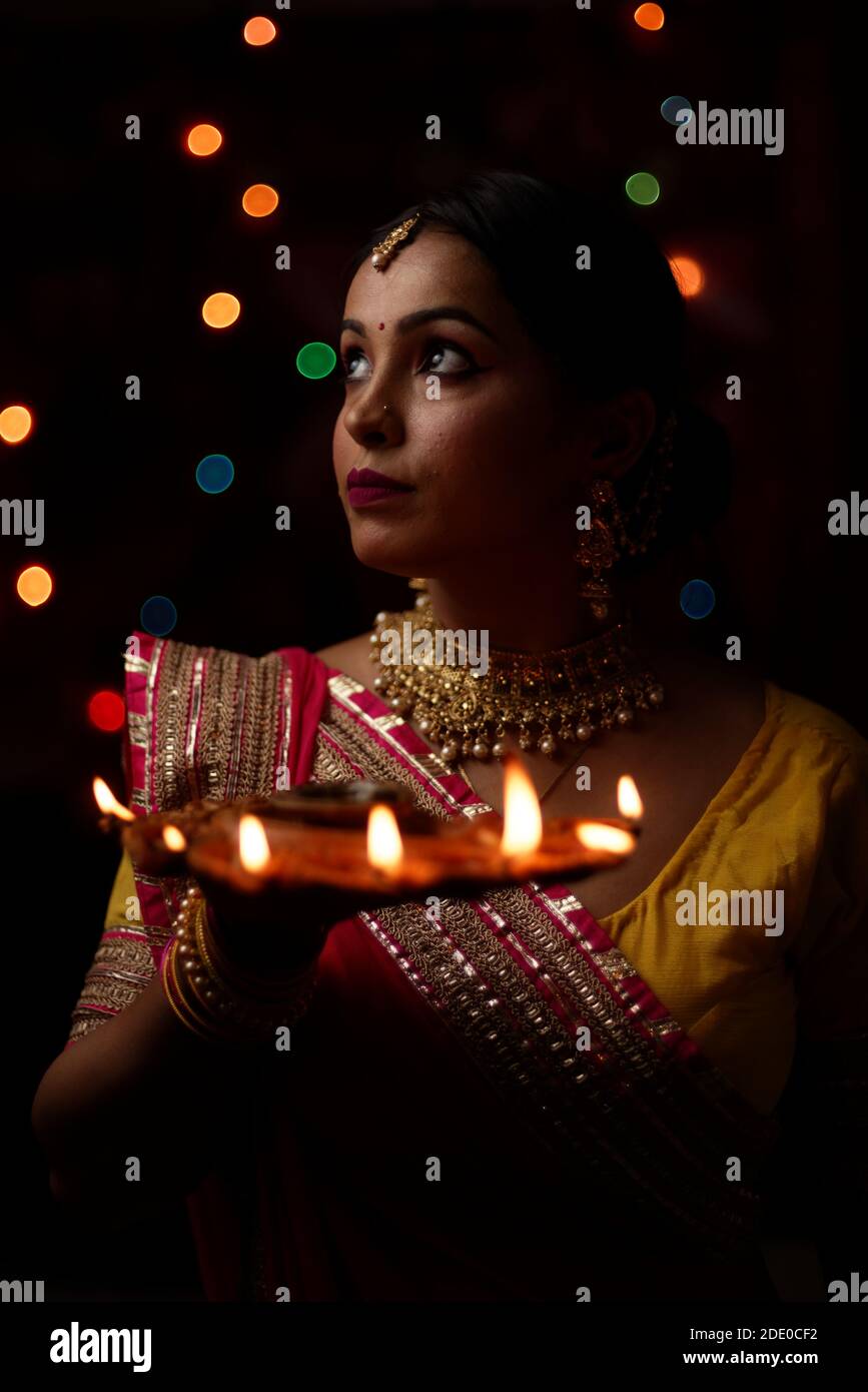 An young and beautiful Indian Bengali woman in Indian traditional dress