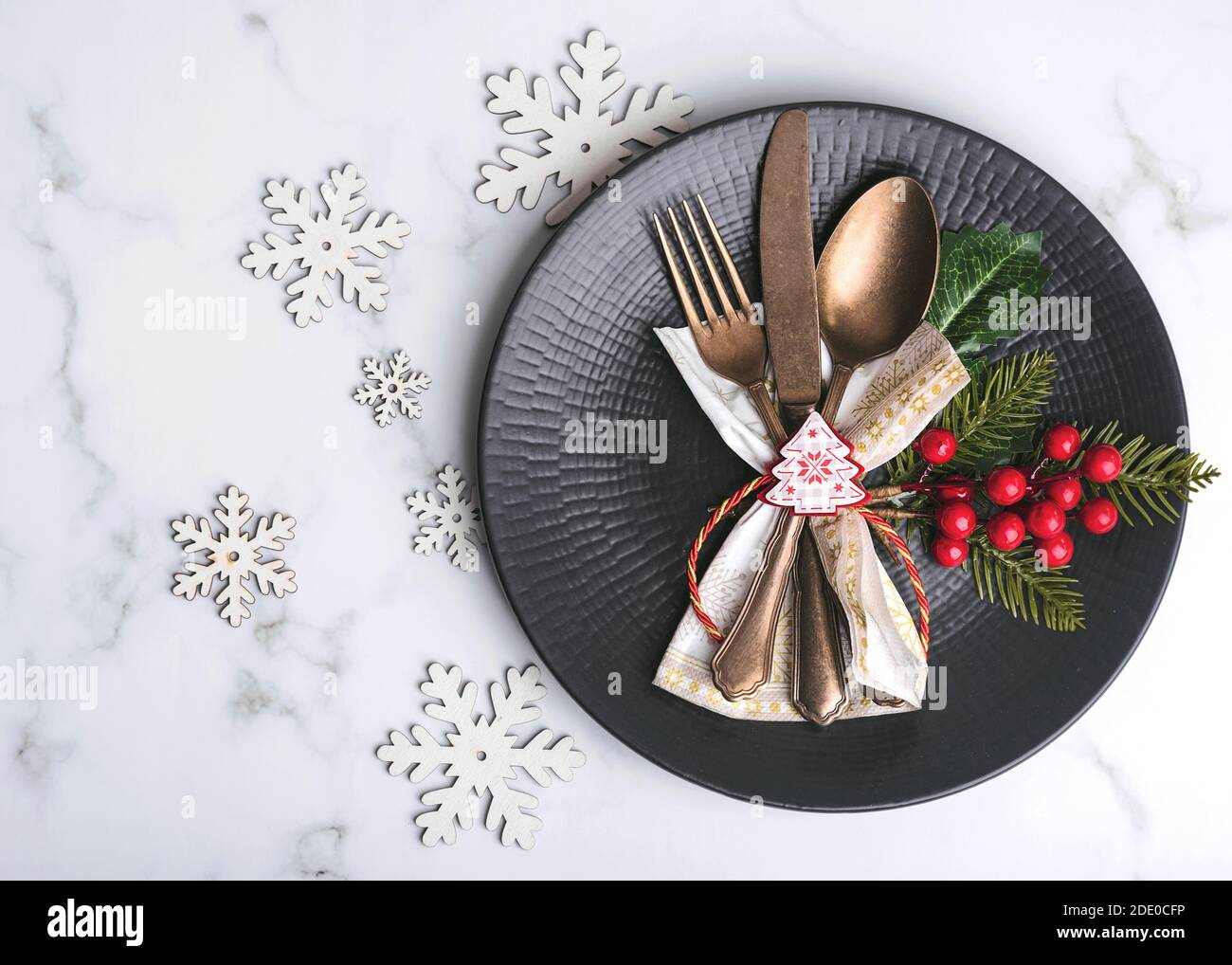 Christmas concept background.Vintage old cutlery served on plate for Christmas dinner on marble table.Christmas concept background Stock Photo
