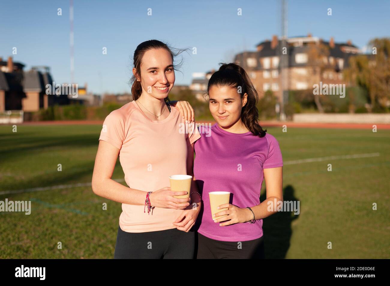 two young sporty women having coffee while chatting Stock Photo Alamy