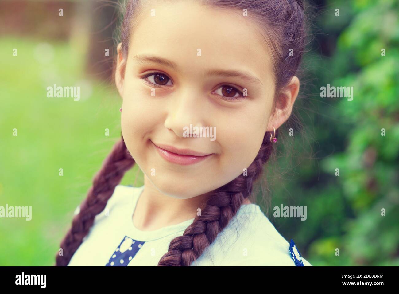 Portrait of pretty young girl with pigtails at sunny day in park Stock ...