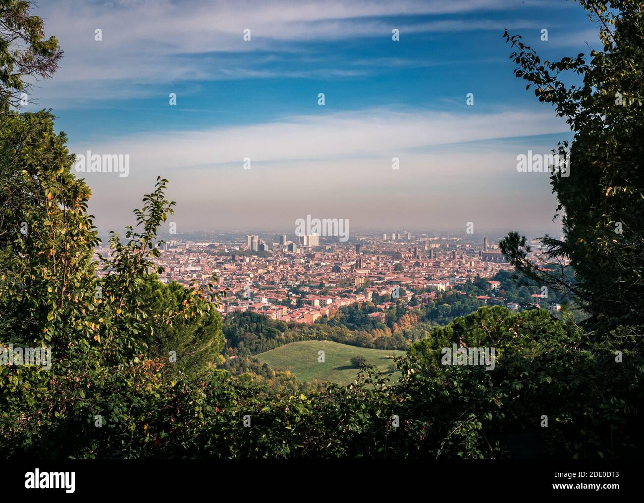 The city of Bologna viewed from the hill of San Luca. The cloud of smog that hangs over the city is clearly visible. Bologna province, Emilia and Roma Stock Photo