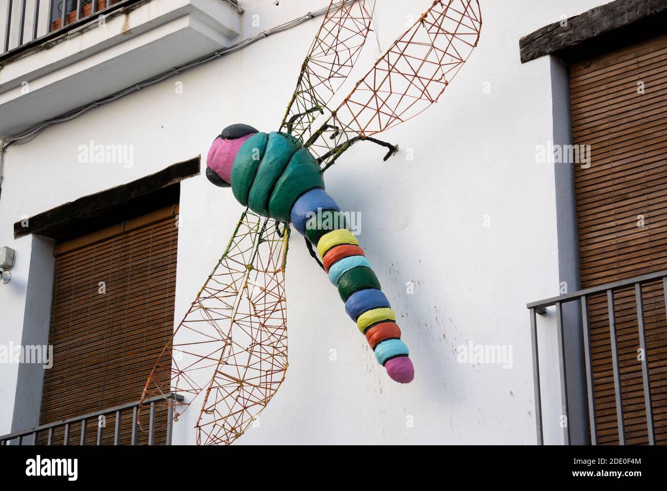 dragonfly sculpture on the wall of a house Stock Photo Alamy