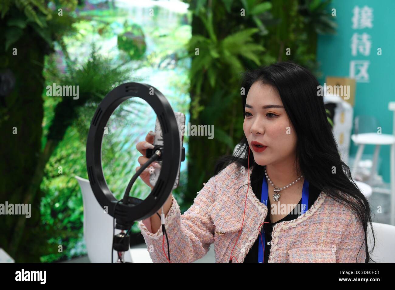 Nanning, China's Guangxi Zhuang Autonomous Region. 27th Nov, 2020. An exhibitor promotes goods via livestreaming at the 17th China-ASEAN Expo in Nanning, south China's Guangxi Zhuang Autonomous Region, Nov. 27, 2020. Credit: Lu Boan/Xinhua/Alamy Live News Stock Photo