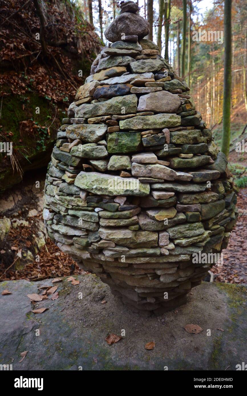 Closeup of stone balance on rock in forest Stock Photo