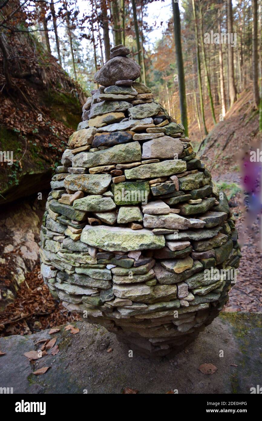 Closeup of stone balance on rock in forest Stock Photo