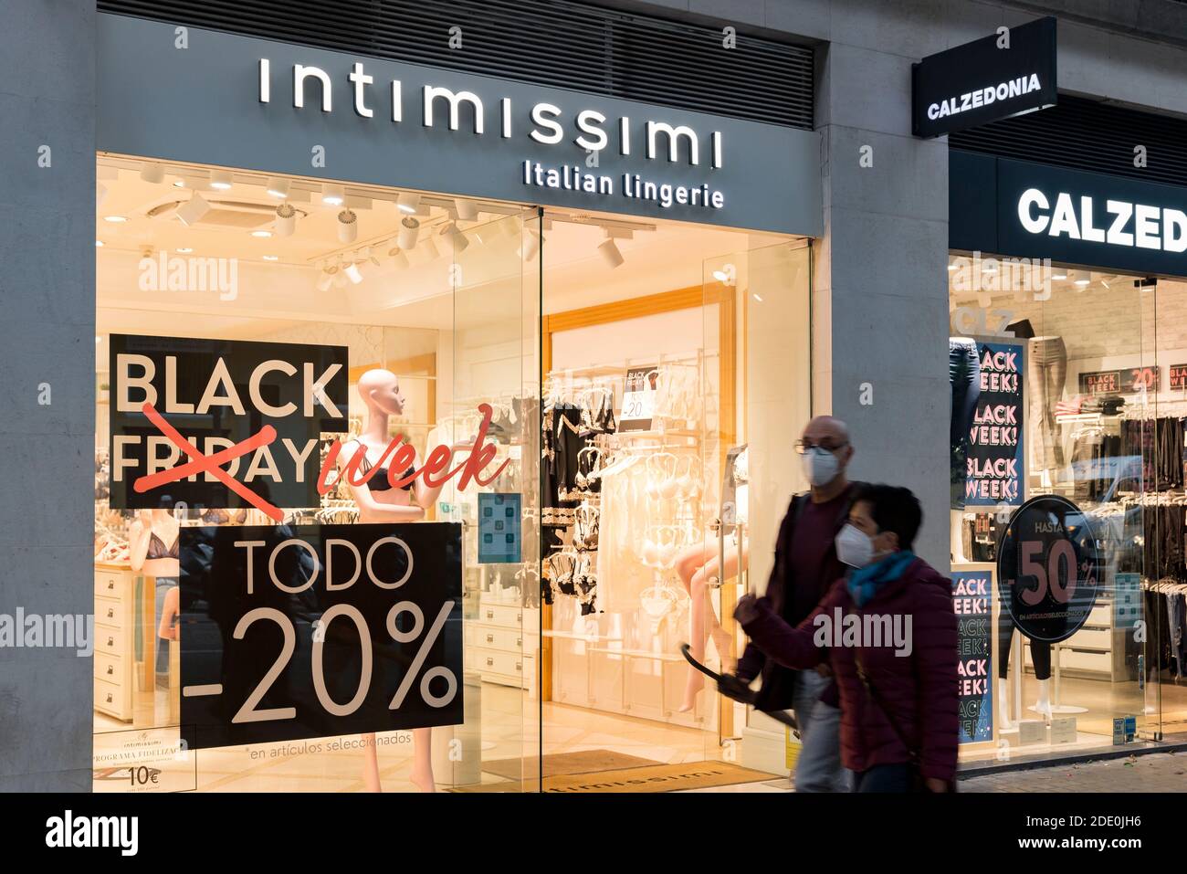 Valencia, Spain. 27th Nov, 2020. People wearing face masks as a precaution  against the spread of covid-19 walking past an advertising banner of Black  Friday in front of the Intimissimi shop during