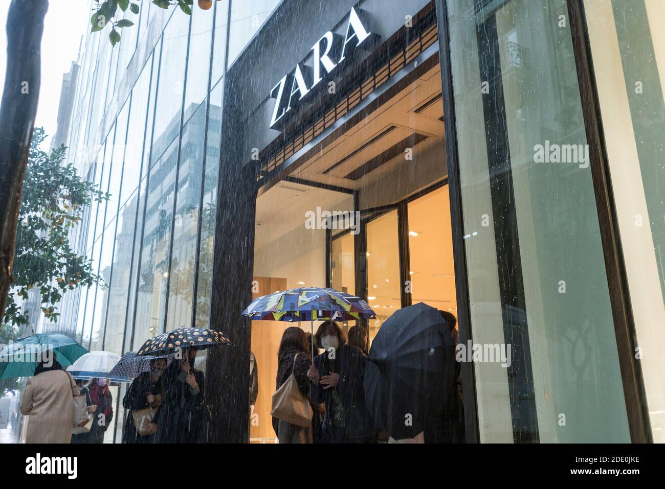 Valencia, Spain. 27th Nov, 2020. People with umbrellas taking shelter in  front of the Zara shop