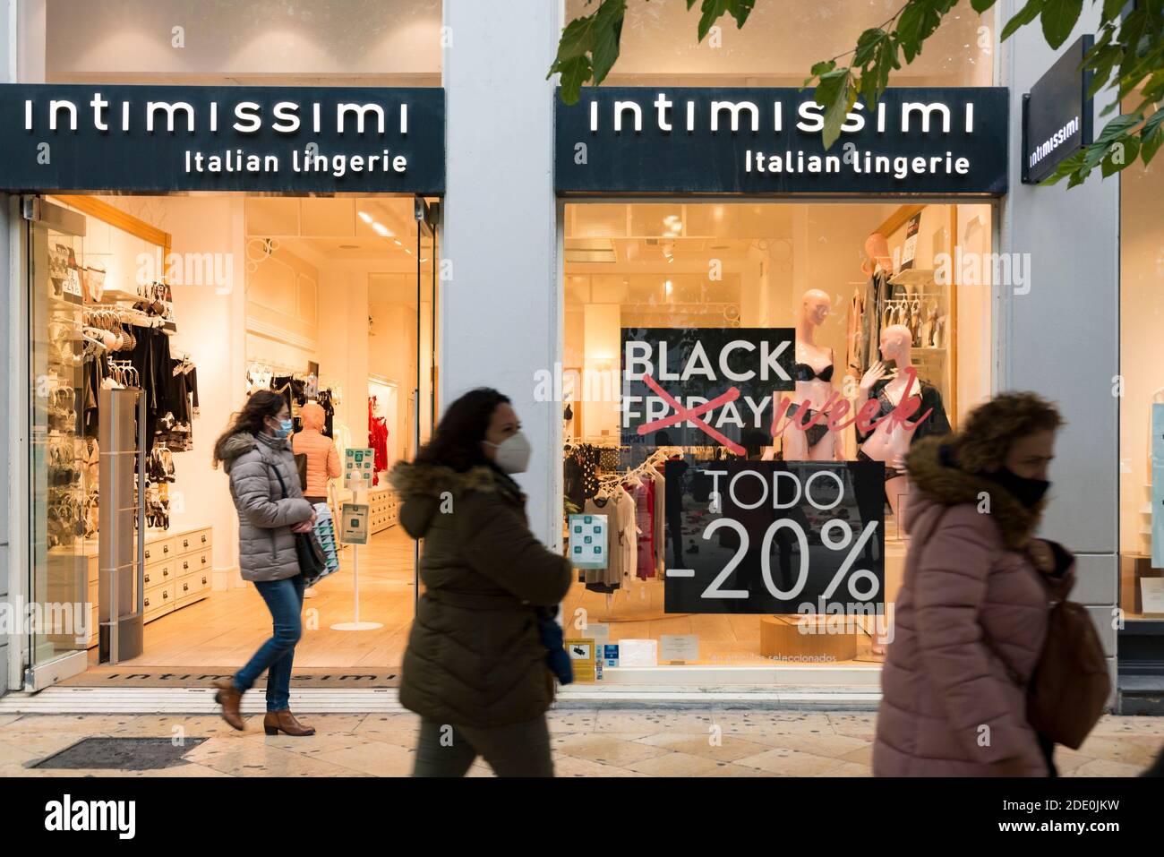 Valencia, Spain. 27th Nov, 2020. People wearing face masks as a precaution  against the spread of covid-19 walking past an advertising banner of Black  Friday in front of the Intimissimi shop during