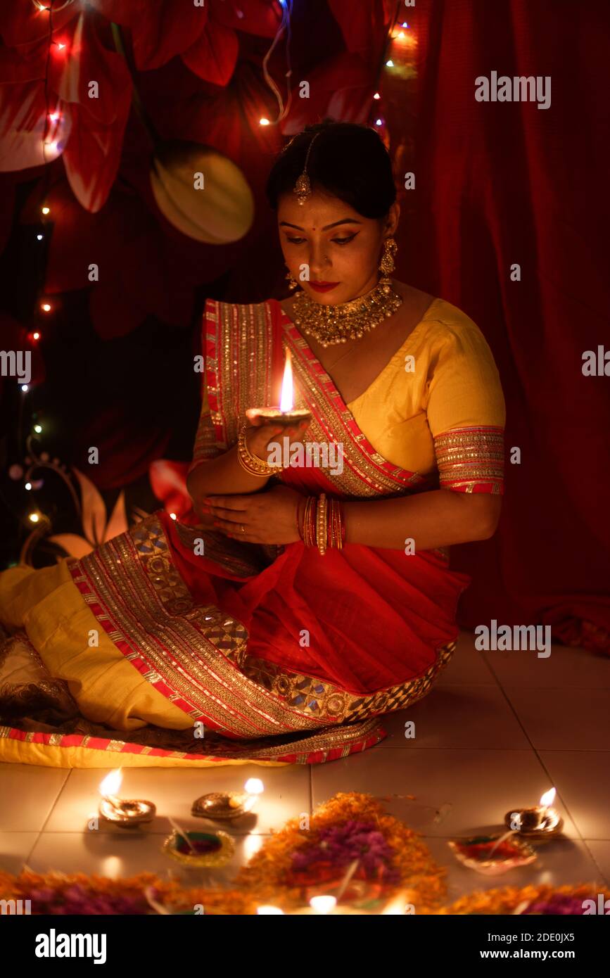 An young and beautiful Indian Bengali woman in Indian traditional dress