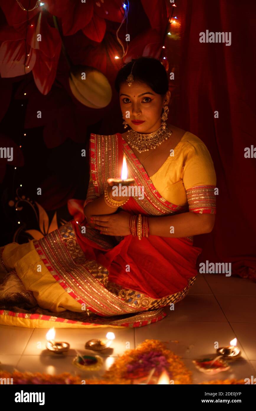 An young and beautiful Indian Bengali woman in Indian traditional dress