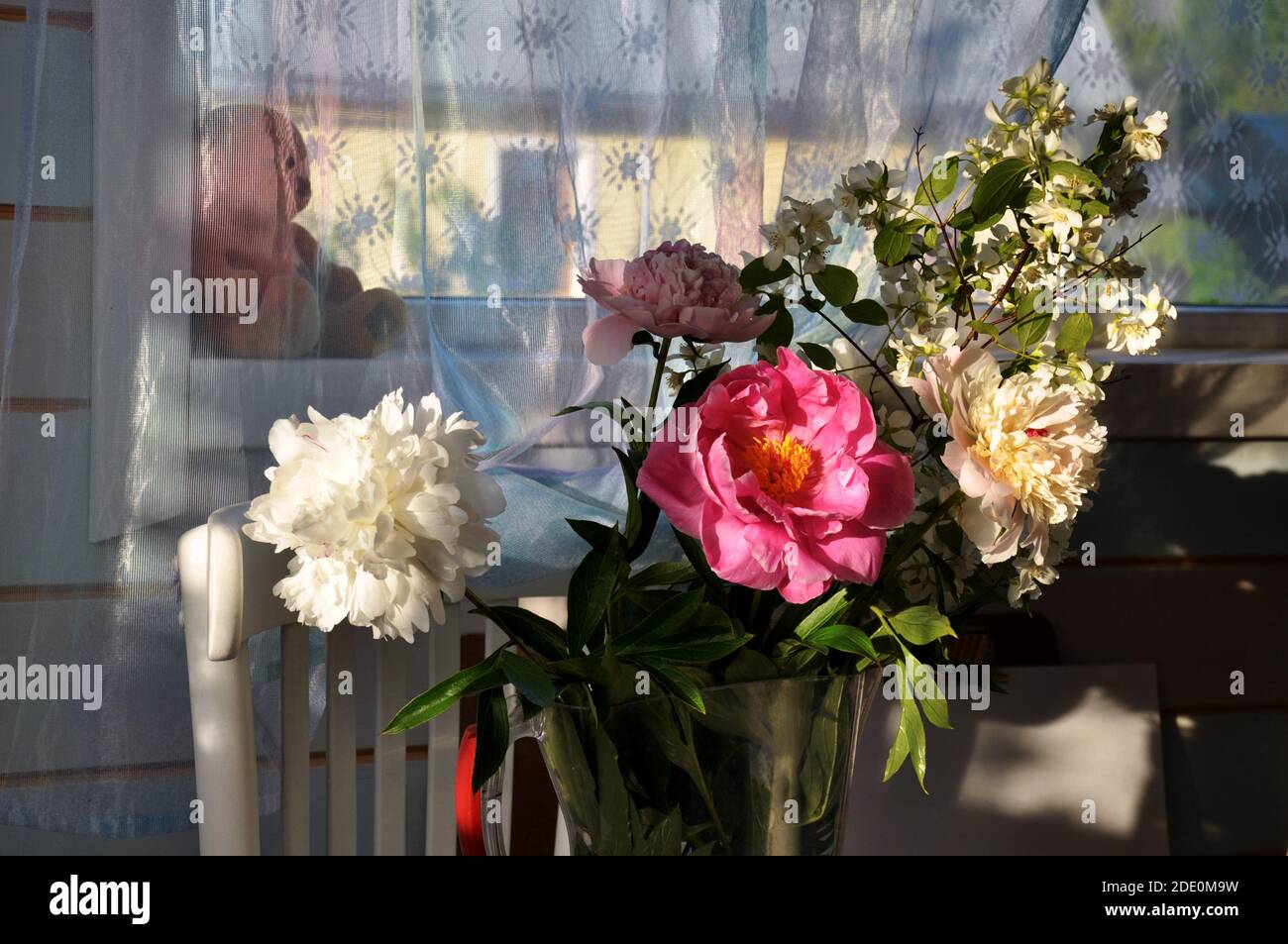 summer bright bouquet with peony and Jasmine flowers on window of country house Stock Photo