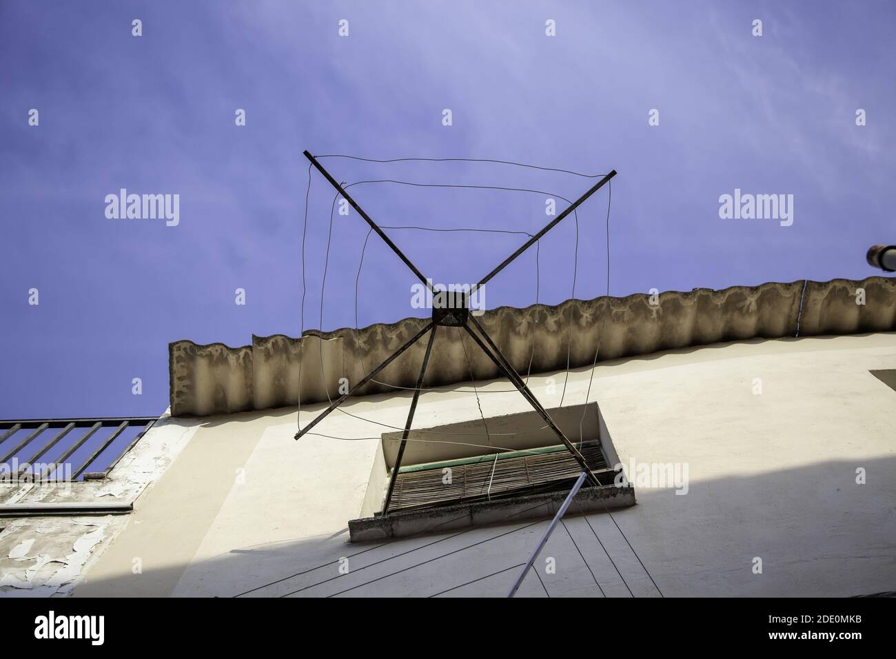 Empty clothesline on the balcony of the house, metal structure and