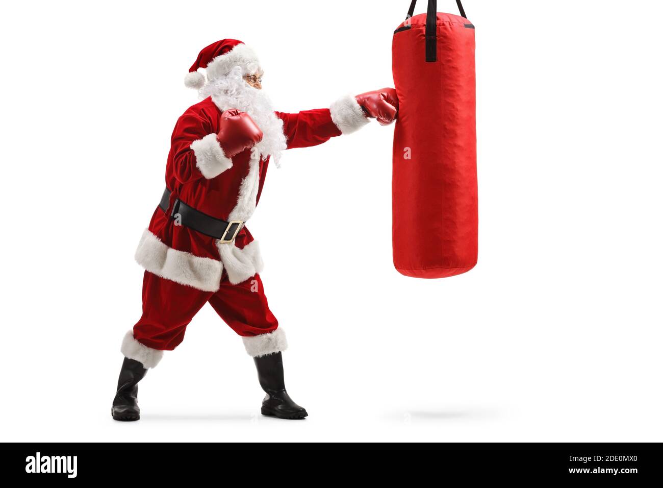 Full length profile shot of santa claus exercising box with gloves and a  punching bag isolated on white background Stock Photo - Alamy