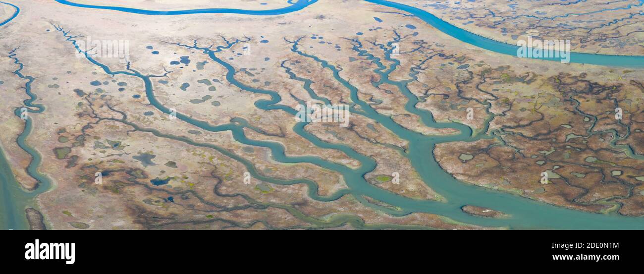 Meandering channels run through a beautiful estuary in Central California. Estuaries form when freshwater runoff meets and mixes with seawater. Stock Photo