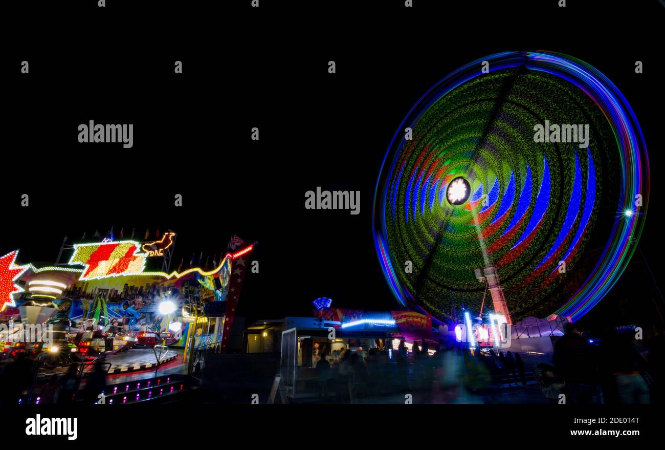 Graz, Austria - October 05, 2019: Ferris wheel in motion in the amusement park, at night. Long exposure photography. Stock Photo