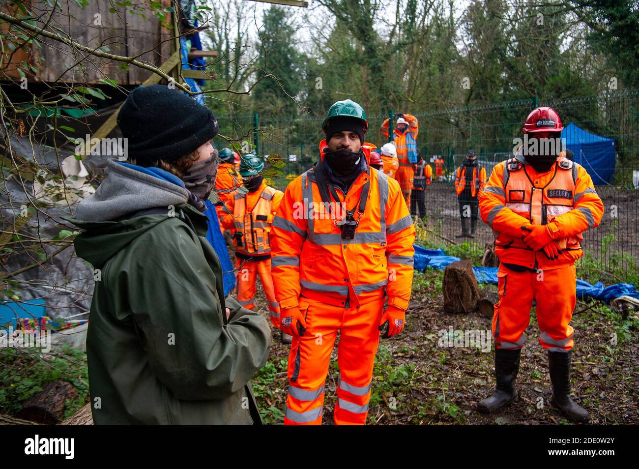 Denham, Buckinghamshire, UK. 27th November, 2020. Today HS2 workers and HS2 security entered the Denham Wildlife Protection Camp in Denham Country Park without permission. The camp is occupied by environmental activists who are living in trees next to an HS2 compound as they try to prevent HS2 from destroying the trees. HS2 arrived in the camp en mass and said it was so they could repair a fence between their compound and the activists camp. Credit: Maureen McLean/Alamy Live News Stock Photo