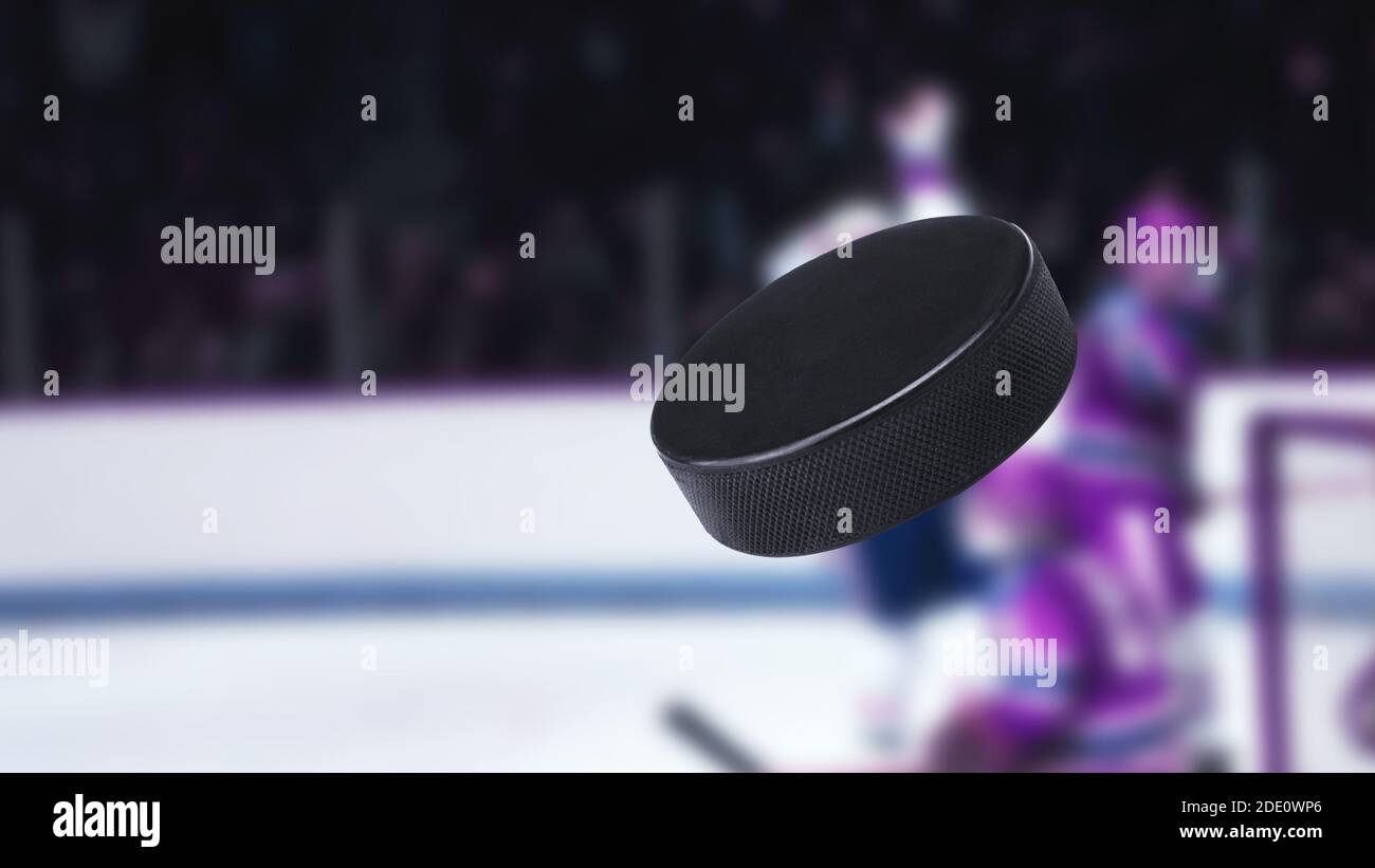 Hockey puck in the air. Close-up. The crowd of fans on a blurred background Stock Photo