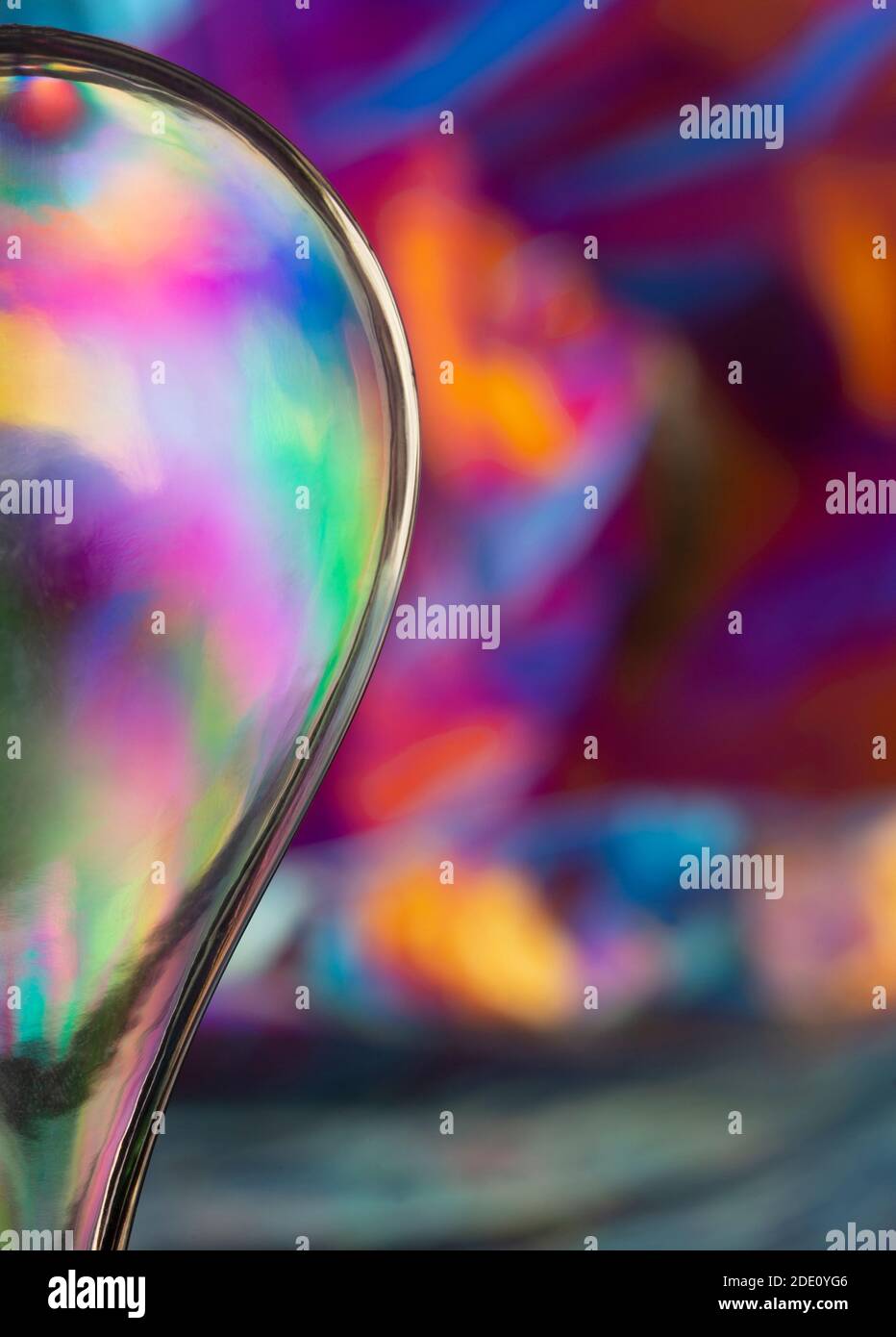 Cross polarisation, multicoloured plastic shape on multicoloured background Stock Photo