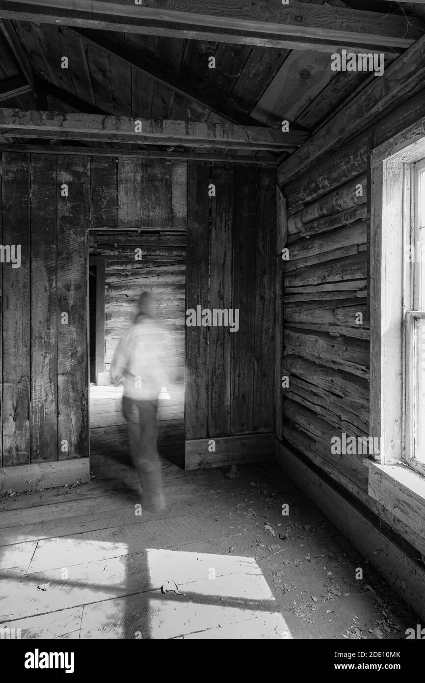 Karen Rentz walking through ranch house at Caroline Lockhart Historic Ranch Site in Bighorn Canyon National Recreation Area, near Lovell, Wyoming, USA Stock Photo